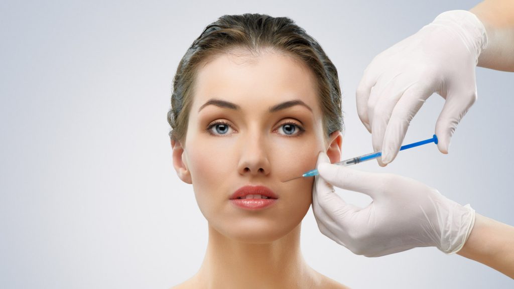 Botox needle on face during botox treatment